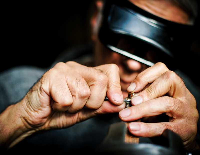 Golani goldsmith touching up a solid 14 karat gold ring