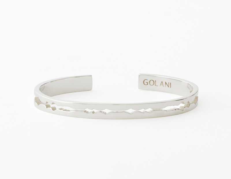The Cut Wave Bracelet placed horizontal in Sterling Silver